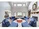Bright living room features a unique circular sofa arrangement and ample natural light at 4181 Whitetail Woods Dr, Bargersville, IN 46106