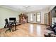 Large room with hardwood floors, a ceiling fan, and windows that let in ample natural light at 4181 Whitetail Woods Dr, Bargersville, IN 46106