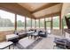 Relaxing sunroom featuring wicker seating, a neutral rug, brick accents, and bright natural light at 4181 Whitetail Woods Dr, Bargersville, IN 46106