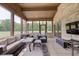 Comfortable outdoor sunroom offers stylish furniture and views of the pool and green scenery at 4181 Whitetail Woods Dr, Bargersville, IN 46106