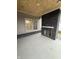 Covered back porch with brick fireplace and concrete floor at 4295 Hamilton Run, Zionsville, IN 46077