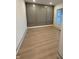 Bedroom featuring grey wainscoting, light wood floors and a window at 4295 Hamilton Run, Zionsville, IN 46077