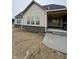 Home exterior with tan siding and black brick foundation at 4295 Hamilton Run, Zionsville, IN 46077