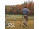 Golfer standing on a green golf course fairway surrounded by scenic trees in the background at 4295 Hamilton Run, Zionsville, IN 46077