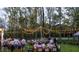 Outdoor gathering with people dining at tables under string lights surrounded by trees at 4295 Hamilton Run, Zionsville, IN 46077