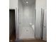 Tiled shower featuring white subway and penny tile and a built-in bench at 4295 Hamilton Run, Zionsville, IN 46077