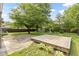 Expansive backyard featuring a wooden deck, patio, shed, privacy fence, and mature trees at 4718 Dancer Dr, Indianapolis, IN 46237