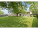 Expansive backyard featuring a well-maintained lawn, privacy fence, and mature shade trees at 4718 Dancer Dr, Indianapolis, IN 46237