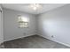 This bedroom features neutral walls, ceiling fan, and a window for natural light at 4718 Dancer Dr, Indianapolis, IN 46237