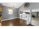 Open dining room with modern lighting, hardwood floors, and a view of the fireplace at 4718 Dancer Dr, Indianapolis, IN 46237