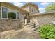 Inviting front entrance with brick accents, steps, wrought iron railing, and landscaped plants at 4718 Dancer Dr, Indianapolis, IN 46237