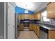 A kitchen featuring light wood cabinets, stainless steel appliances, and tile flooring at 4718 Dancer Dr, Indianapolis, IN 46237