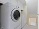 Laundry room with washer and dryer and overhead shelving at 4718 Dancer Dr, Indianapolis, IN 46237