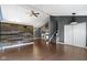 Bright living room with wood wall, hardwood floors, vaulted ceilings and stairs at 4718 Dancer Dr, Indianapolis, IN 46237