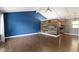 Bright living room with wood wall, hardwood floors, and vaulted ceilings at 4718 Dancer Dr, Indianapolis, IN 46237