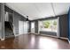 Spacious living room with hardwood floors, a large window, and access to the staircase at 4718 Dancer Dr, Indianapolis, IN 46237