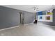 An open living room with tile flooring, access to the laundry room, and view of the upper level at 4718 Dancer Dr, Indianapolis, IN 46237