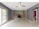 Living room featuring a brick fireplace, built-in shelving, and a sliding glass door at 4718 Dancer Dr, Indianapolis, IN 46237