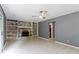 Living room with brick fireplace, built-in shelving, and tile flooring at 4718 Dancer Dr, Indianapolis, IN 46237