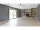 Cozy living room with a brick fireplace, built-in shelves, and a sliding glass door to the backyard at 4718 Dancer Dr, Indianapolis, IN 46237