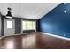 Bright living room with vaulted ceilings, hardwood floors, and a large window overlooking the front yard at 4718 Dancer Dr, Indianapolis, IN 46237