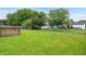 The backyard features a lush lawn and mature trees at 5380 Collett E Dr, Camby, IN 46113