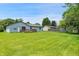 Large backyard boasts green grass, back deck and partial fence at 5380 Collett E Dr, Camby, IN 46113