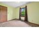 Bright bedroom features neutral carpeting and a window with backyard view at 5380 Collett E Dr, Camby, IN 46113