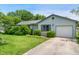 Charming single-story home with light blue siding, an attached garage, and well-maintained front yard at 5380 Collett E Dr, Camby, IN 46113