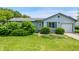 Charming single-story home with light blue siding, an attached garage, and lush front yard landscaping at 5380 Collett E Dr, Camby, IN 46113