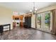 The spacious kitchen features dark appliances, laminate flooring, and doors to the backyard at 5380 Collett E Dr, Camby, IN 46113