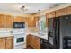The kitchen has ample cabinet space with white appliances and modern features at 5380 Collett E Dr, Camby, IN 46113