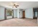 Bright and spacious living room featuring a large window, neutral carpet, and fresh paint at 5380 Collett E Dr, Camby, IN 46113