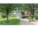 Backyard shed with a wooden access path, landscaping, and lush green grass at 5431 Nathan Pl, Indianapolis, IN 46237