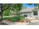 Landscaped backyard featuring a stone garden, lush foliage, and a well-maintained lawn at 5431 Nathan Pl, Indianapolis, IN 46237