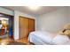 Comfortable bedroom with closet, warm wood floors, a single bed and neutral color palette at 5431 Nathan Pl, Indianapolis, IN 46237