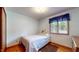 Cozy bedroom offers neutral color palette, natural light and comfortable single bed at 5431 Nathan Pl, Indianapolis, IN 46237