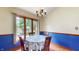 Bright dining area featuring large window, chandelier and wood flooring at 5431 Nathan Pl, Indianapolis, IN 46237