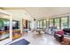 Bright sunroom featuring tile floors, large windows, and a vaulted ceiling at 5431 Nathan Pl, Indianapolis, IN 46237