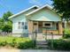 Charming home featuring a white front door, brick accents, and a well maintained front yard at 547 N Livingston Ave, Indianapolis, IN 46222