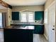 Beautiful kitchen with dark green cabinets, wood island, and updated countertops at 547 N Livingston Ave, Indianapolis, IN 46222