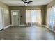 Living room showcasing wood floors, ceiling fan, and an open door at 547 N Livingston Ave, Indianapolis, IN 46222