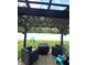 Outdoor patio area features a pergola, seating, and a view of the fenced backyard at 5702 Deer Valley Ct, Columbus, IN 47201