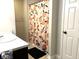 Bathroom featuring a vanity with a sink, toilet, and a shower with a peach patterned curtain at 5702 Deer Valley Ct, Columbus, IN 47201