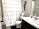 Bathroom features a decorative shower curtain and black vanity with marble countertop at 5702 Deer Valley Ct, Columbus, IN 47201