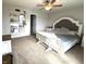 Bright bedroom with a decorative headboard, fan, and white nightstands, creating a serene and inviting atmosphere at 5702 Deer Valley Ct, Columbus, IN 47201