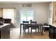 Inviting dining area with a wooden table and chairs, adjacent to a sliding glass door to the backyard at 5702 Deer Valley Ct, Columbus, IN 47201