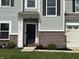 Charming home featuring a black front door, brick accents, and manicured landscaping in a welcoming front yard at 5702 Deer Valley Ct, Columbus, IN 47201