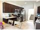 Well-lit kitchen features stainless steel appliances, granite countertops, and dark wood cabinetry at 5702 Deer Valley Ct, Columbus, IN 47201