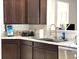 Close-up of the kitchen with granite countertops, stainless steel appliances, and dark wood cabinets at 5702 Deer Valley Ct, Columbus, IN 47201